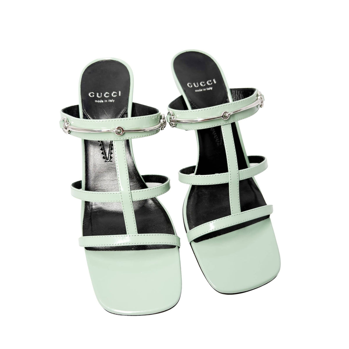 Symmetrical front-facing studio view of a pair of Pacific Green Gucci Regent heeled sandals side-by-side, emphasizing the open toe box.
