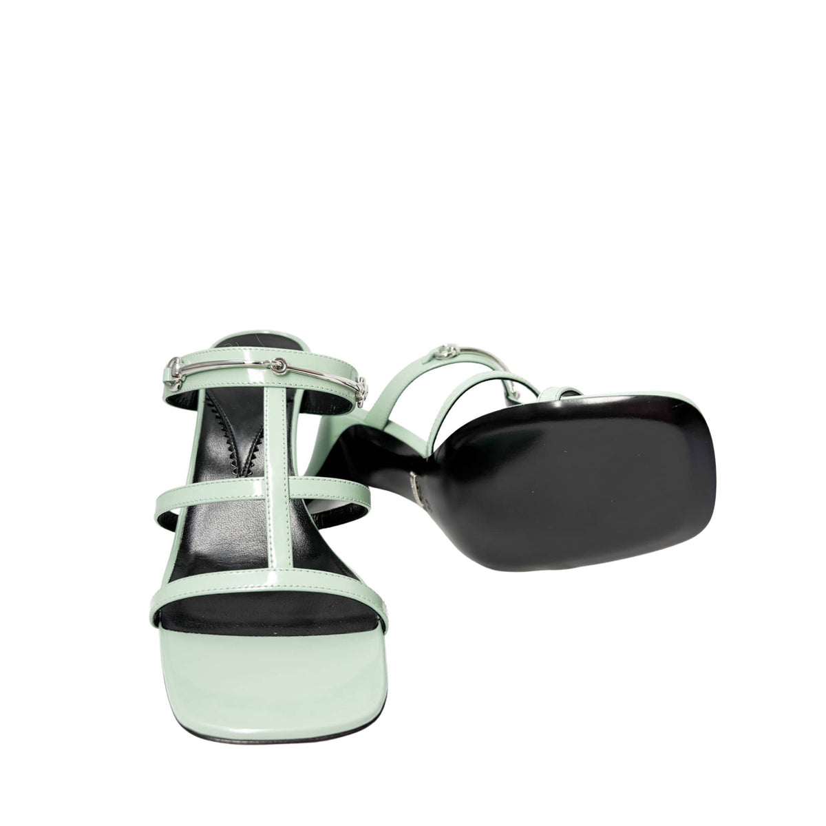 Rear view of the Pacific Green Gucci Regent sandals from behind, focusing on the symmetrical stiletto heels and minimal heel counters.