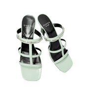 Close-up level shot of the Gucci Regent heeled sandal resting on its side, showing the clean profile lines and open toe design.