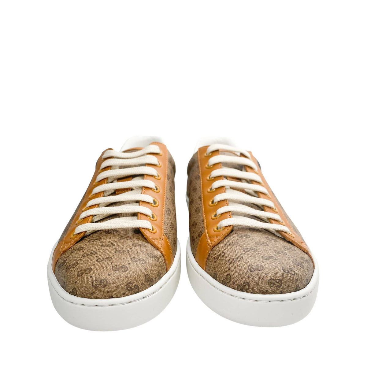 Frontal view of a pair of Gucci x Disney Mickey Mouse Ace sneakers displaying white laces and round toes.