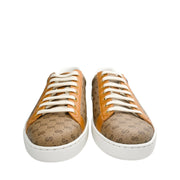 Frontal view of a pair of Gucci x Disney Mickey Mouse Ace sneakers displaying white laces and round toes.
