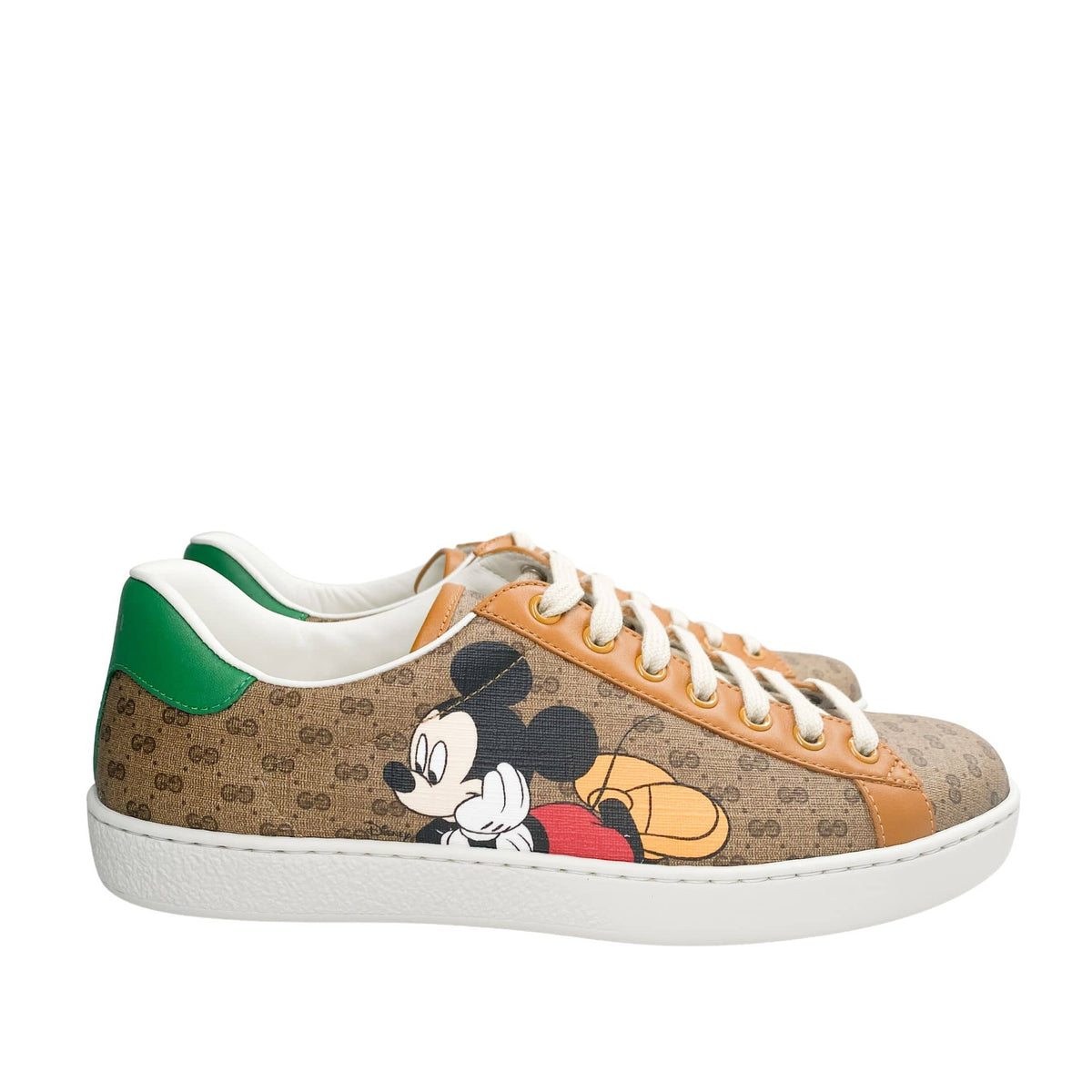 Side profile view of Gucci x Mickey Mouse Ace sneaker showing GG canvas pattern and white rubber sole.