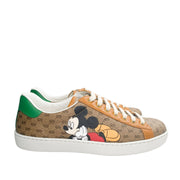 Side profile view of Gucci x Mickey Mouse Ace sneaker showing GG canvas pattern and white rubber sole.