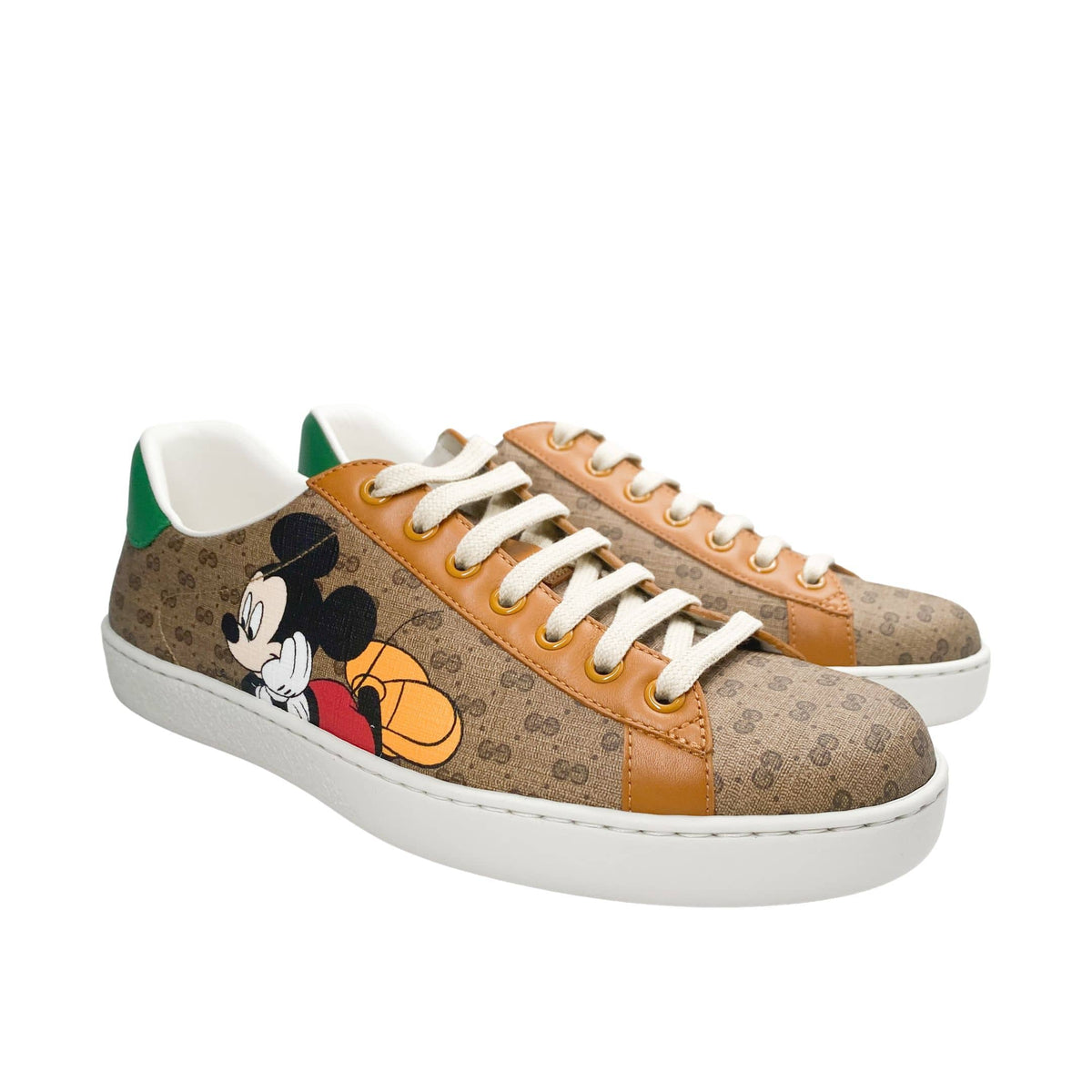 Three-quarter angled pair view of Gucci x Mickey Mouse Ace GG Supreme canvas designer trainers.