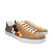 Three-quarter angled pair view of Gucci x Mickey Mouse Ace GG Supreme canvas designer trainers.