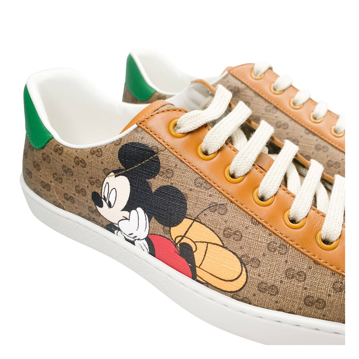 Elevated three-quarter view of men's Gucci x Mickey Mouse Ace sneakers showing low-top profile.