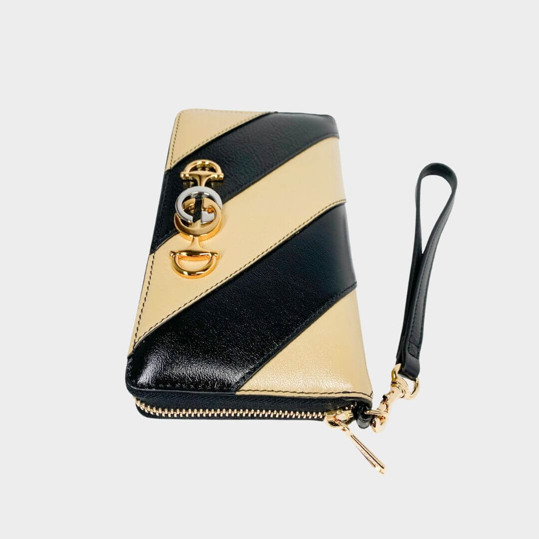 Gucci Zumi zip-around wallet in black and beige diagonal striped leather with mixed gold and silver Interlocking G Horsebit logo