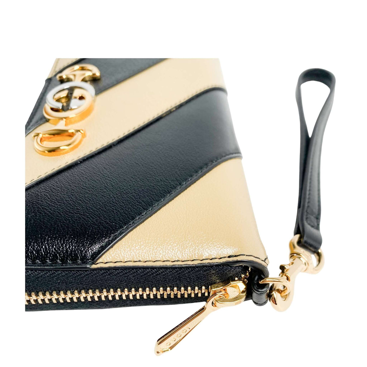 Top view of Gucci Zumi black and beige leather wallet showing gold-toned zip closure and leather wristlet strap attachment