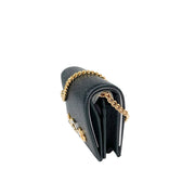 Side profile view of the compact Gucci Zumi black leather card holder, demonstrating its slim structured expansion.