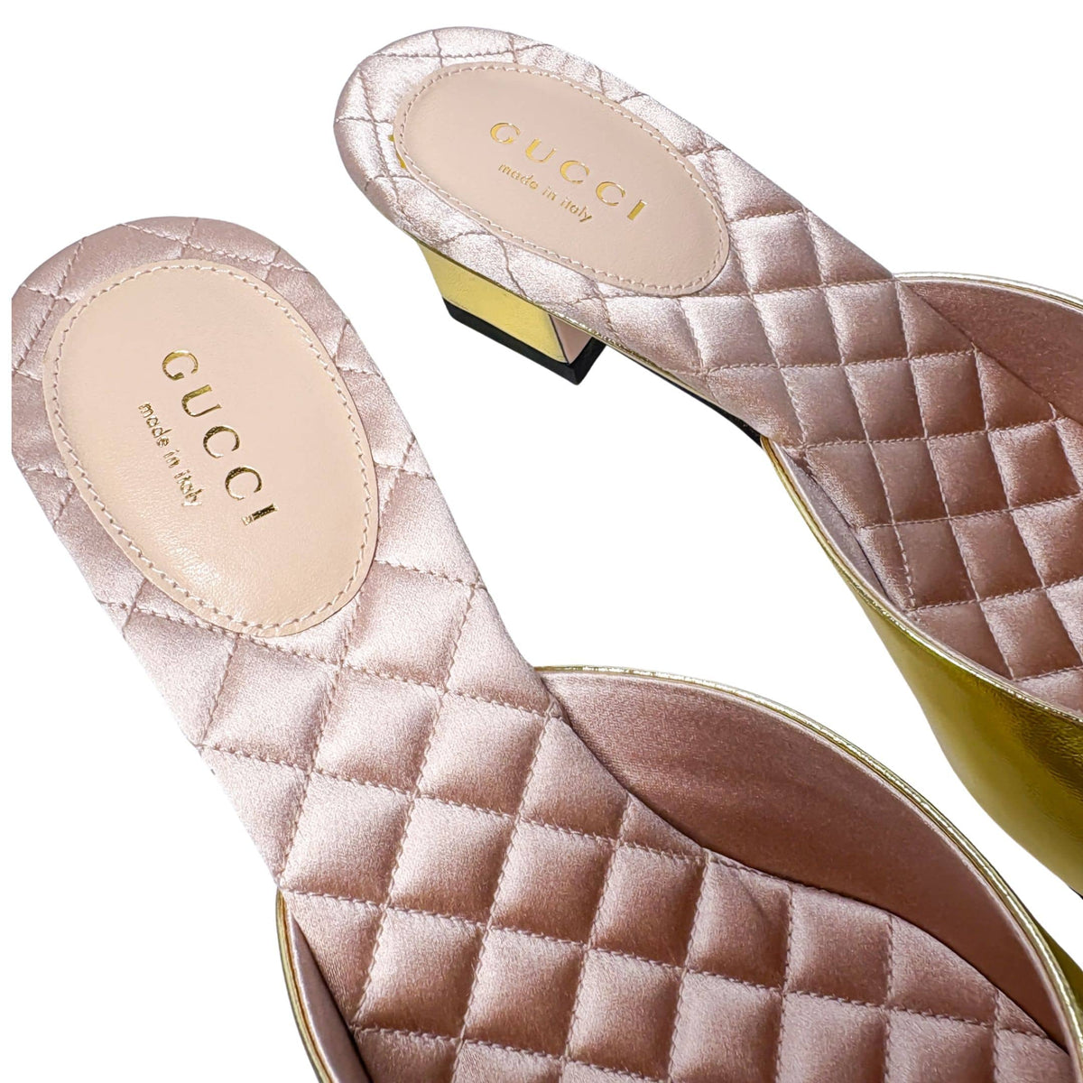 Macro detail shot focusing on the stitched pink quilted leather footbed and stitched edge of the Gucci metallic gold slip-on shoe.