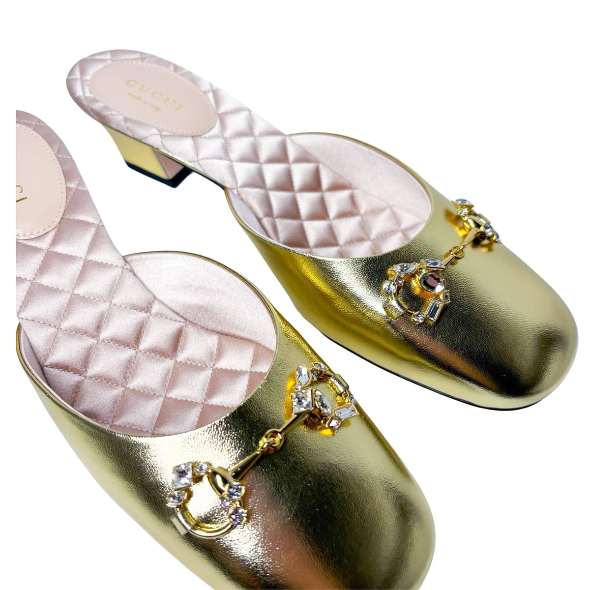 Overhead parallel view of the gold Gucci Diamond Horsebit mules, showcasing the brilliant reflection of the crystal details on the round toe straps.