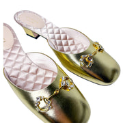 Overhead parallel view of the gold Gucci Diamond Horsebit mules, showcasing the brilliant reflection of the crystal details on the round toe straps.