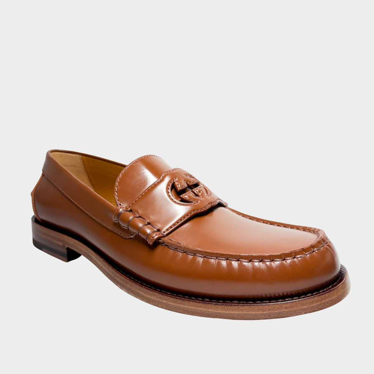Gucci Millennial Ribot brown leather loafer side profile view showing smooth leather finish and classic moccasin stitching.