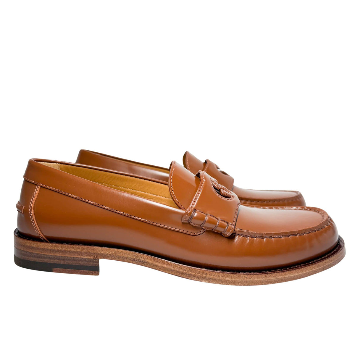 Side profile layout view of Gucci Millennial Ribot brown leather loafer showing clean lines and low-profile design.