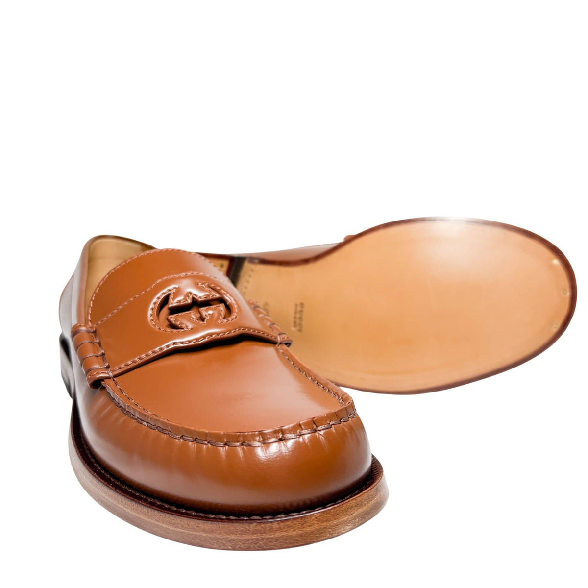 Angled side view of Gucci Millennial Ribot brown leather loafer detailing the refined welt stitching and leather construction.