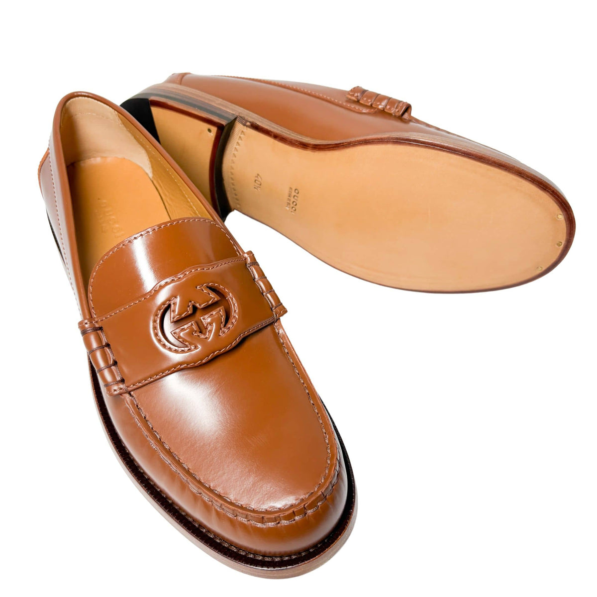 Side profile view of Gucci Millennial Ribot brown leather loafer detailing the durable leather outsole and low flat heel.
