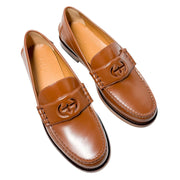 Overhead three-quarter view of Gucci Millennial Ribot brown leather loafers highlighting the soft leather upper and opening collar.