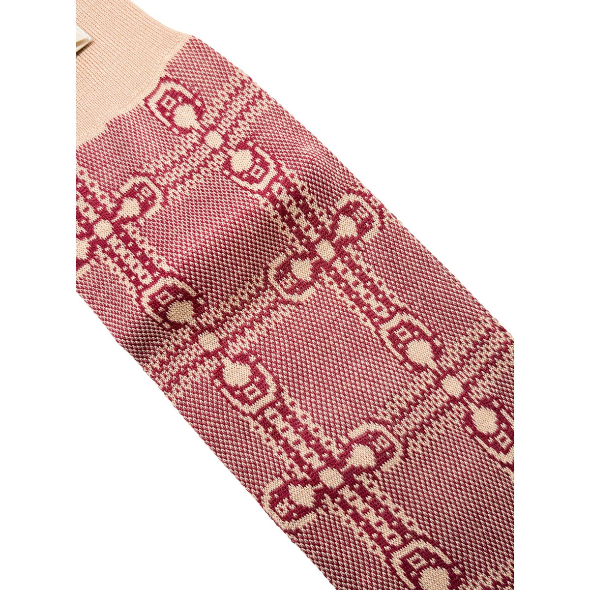 Close-up view of the ribbed top cuff and soft knit texture on the Gucci red and ivory interlocking GG long socks.