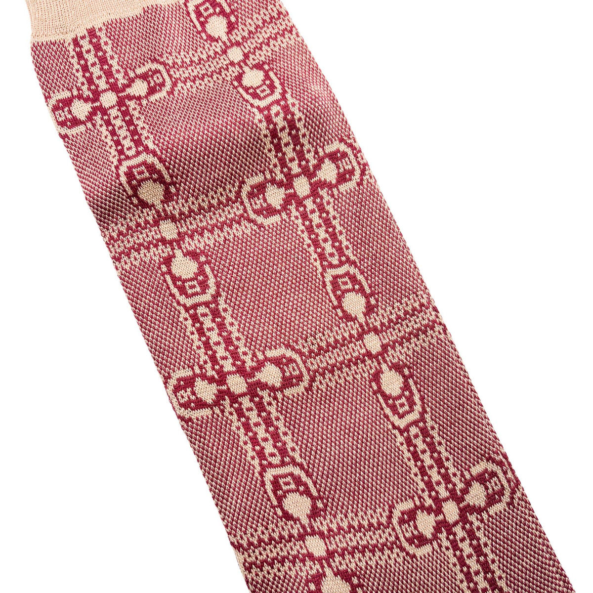 Detailed close-up shot of the vintage athletic-inspired GG monogram knit pattern on the Gucci red and ivory socks.
