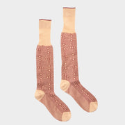Pair of Gucci red and ivory long socks featuring an all-over interlocking GG logo pattern made from soft cotton blend.