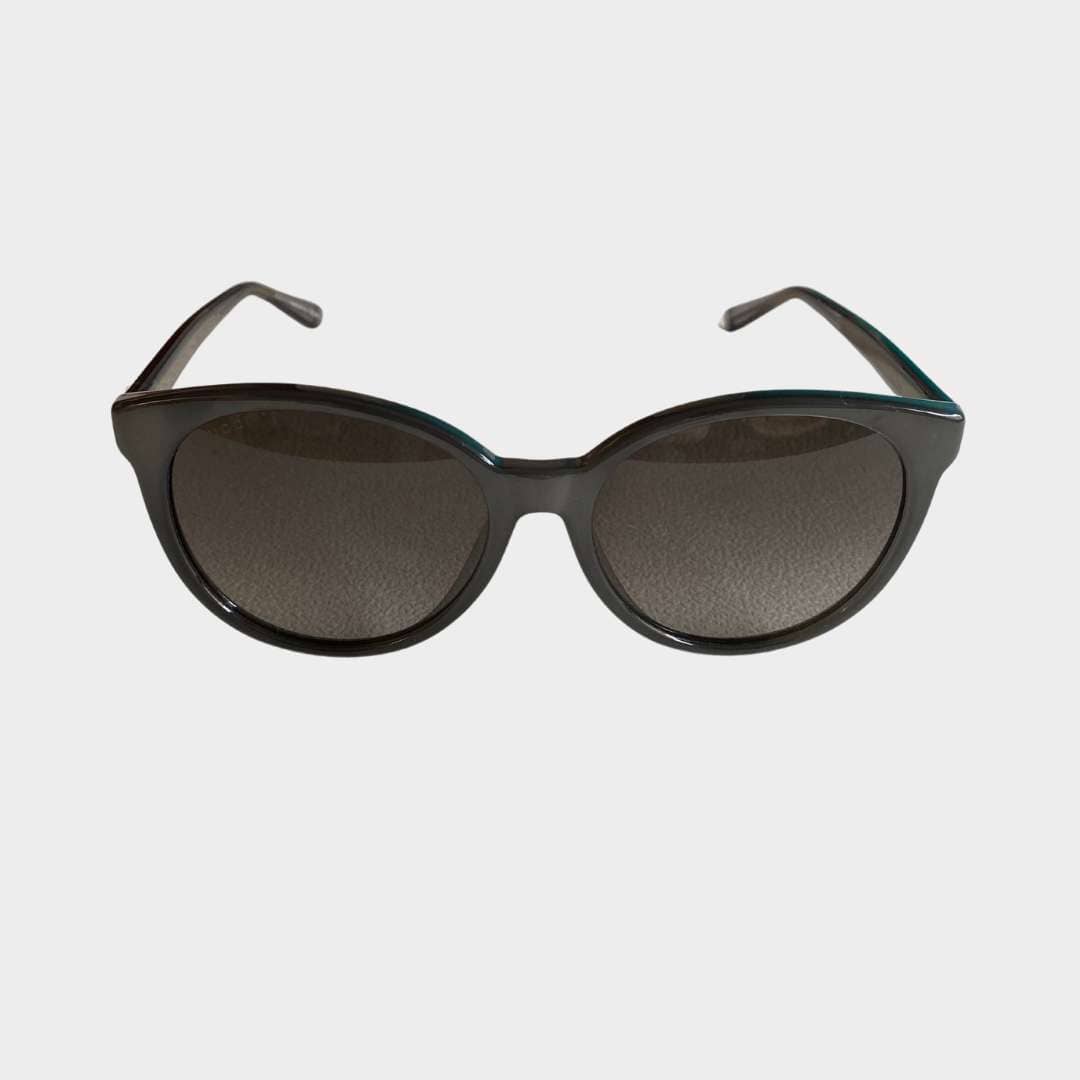Front view of authentic Gucci women's cat-eye sunglasses in black with dark gradient lenses