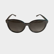 Front view of authentic Gucci women's cat-eye sunglasses in black with dark gradient lenses