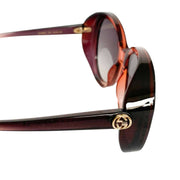 Three-quarter angled view of Gucci round sunglasses, showcasing the iconic gold bee emblem detail on the temple hinge.