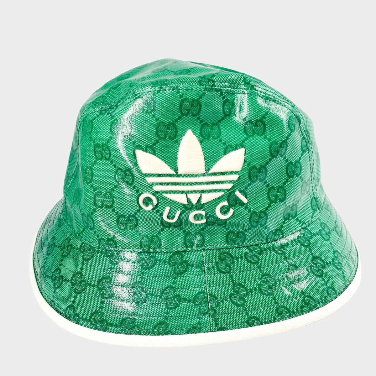 Authentic Gucci x Adidas green and white bucket hat showcasing sporty style and Italian craftsmanship