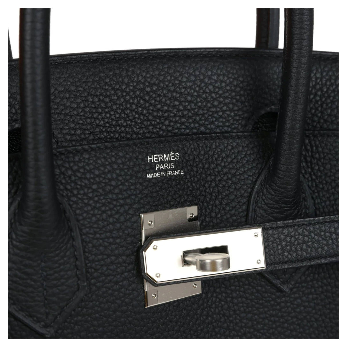 Close-up detail of silver palladium touret turn-lock, sangles, and front flap mechanism on Hermès Birkin 30.