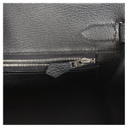 Macro detail view of interior blind stamp and zip pocket inside the black Togo Hermès Birkin 30 bag.