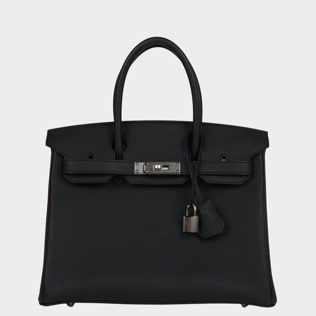 Front view of Hermès Birkin 30 bag in black Togo leather with silver palladium hardware, padlock, and clochette.