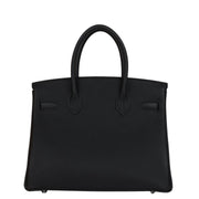 Rear view of Hermès Birkin 30 handbag in black Togo leather showcasing clean paneling and sturdy rolled handles.