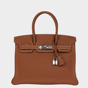 Front view of Hermès Birkin 30 handbag in Gold Togo leather featuring silver palladium hardware, padlock, and clochette.