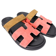 Birds-eye view of the multi-toned Hermès Chypre sandals placed parallel, highlighting the smooth black lambskin lining inside the straps.