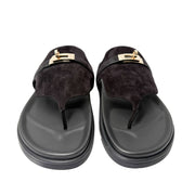 Clean, level horizontal view of a single red and brown Hermès Chypre shoe, showcasing the exact low profile of the $1.2\text{ cm}$ flat sole.