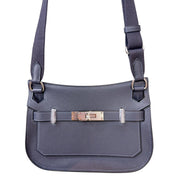 Direct front view of Hermès Jypsière crossbody bag displaying front flap closure, sangles, and polished palladium hardware.