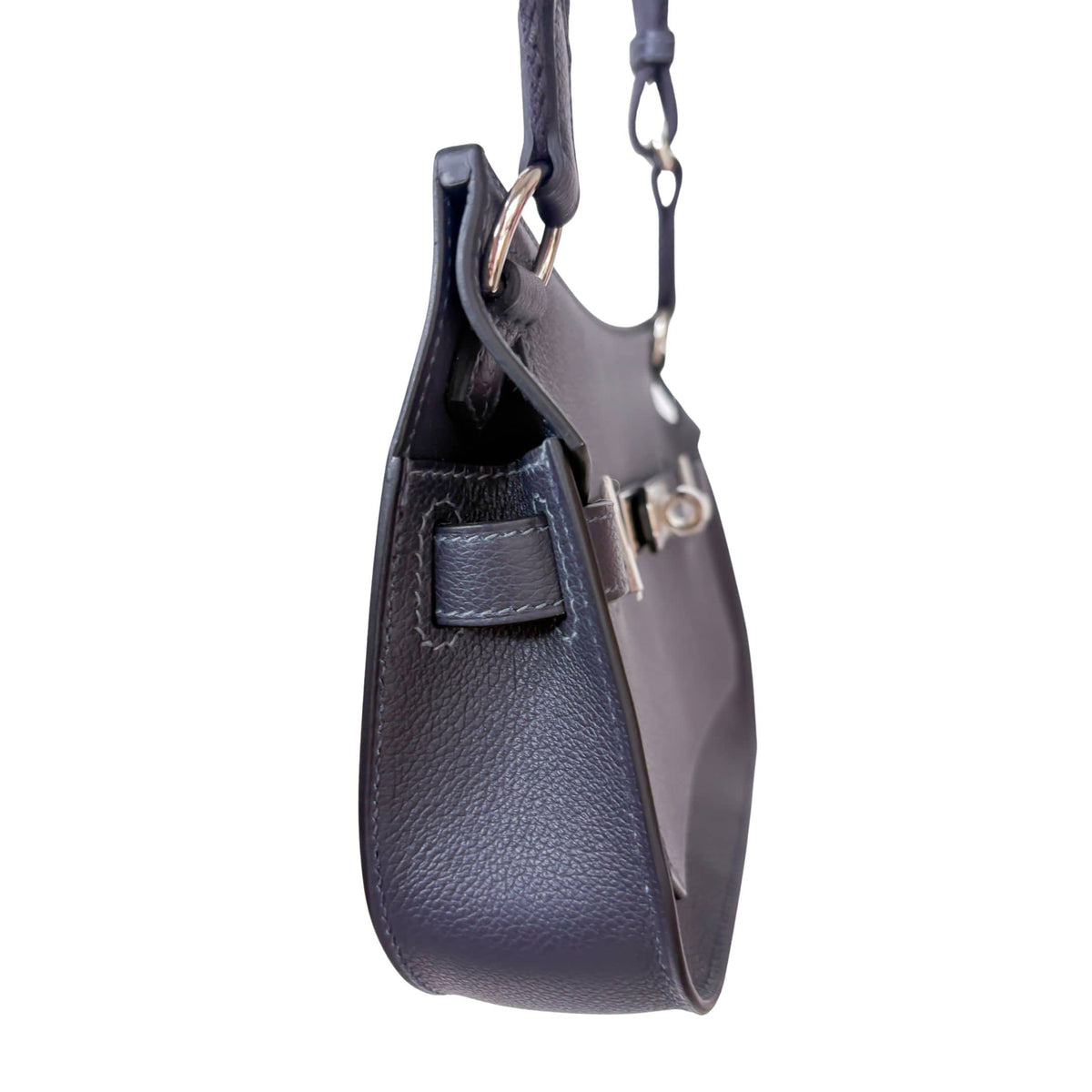 Side profile view of Hermès Jypsière leather handbag detailing side gussets and secure shoulder strap attachment.