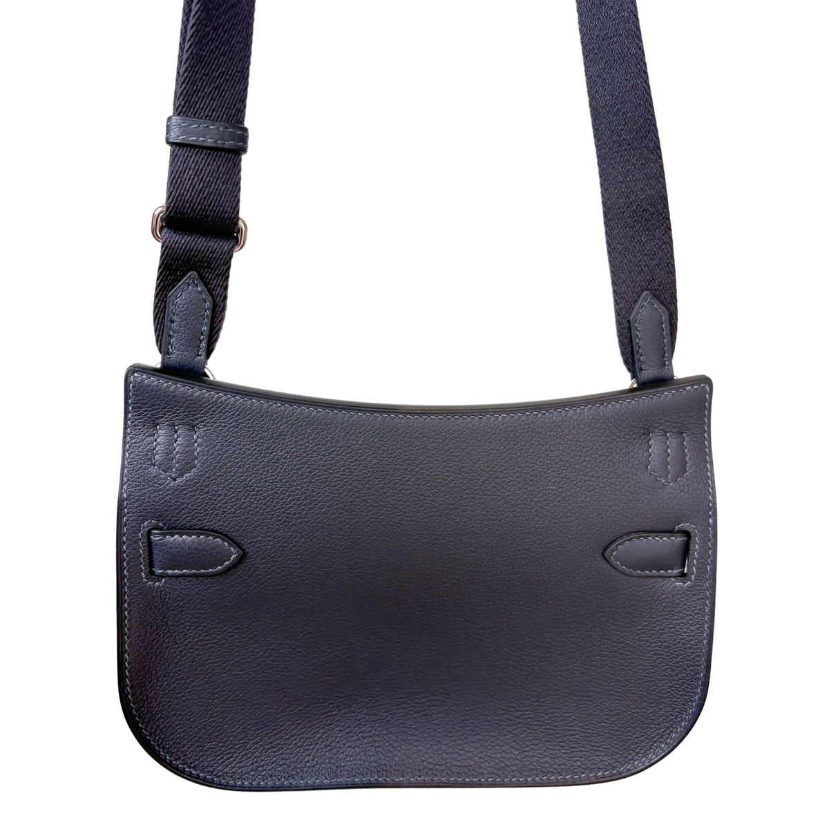 Rear view of Hermès Jypsière leather messenger bag showing clean back panel and structured saddle bag silhouette.