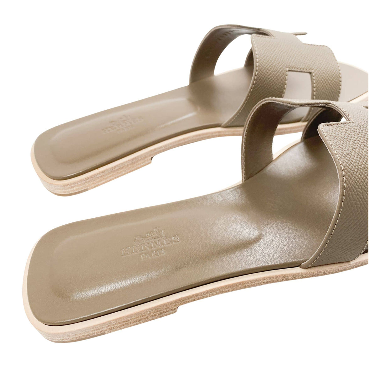 A close look at the sandal resting at a three-quarter angle, illustrating the low-profile height and minimal structure characteristic of timeless resort footwear.