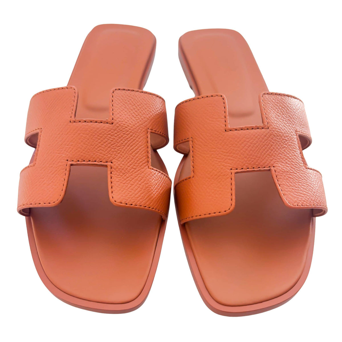 A direct overhead view of the pair, highlighting the matching orange stitched insoles and the elegant open-toe silhouette.
