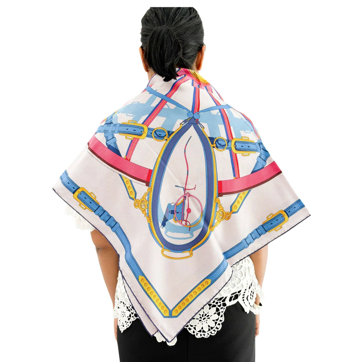 Back view of Hermès En Roue Libre 90cm silk scarf draped over model shoulders showcasing full graphic print and hand-rolled hem