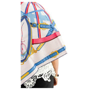 Side view of model wearing Hermès En Roue Libre multicolored silk scarf styled over a black outfit