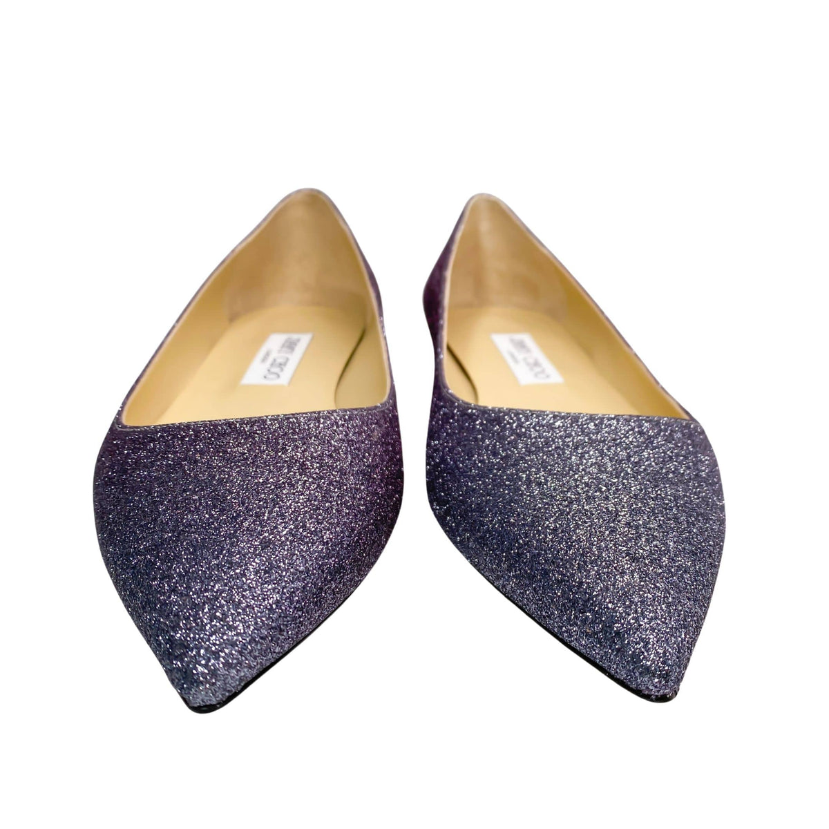 A direct glance at the inner ivory leather lining of the pointed flats, showcasing the clean dual-toned silhouette and polished construction.