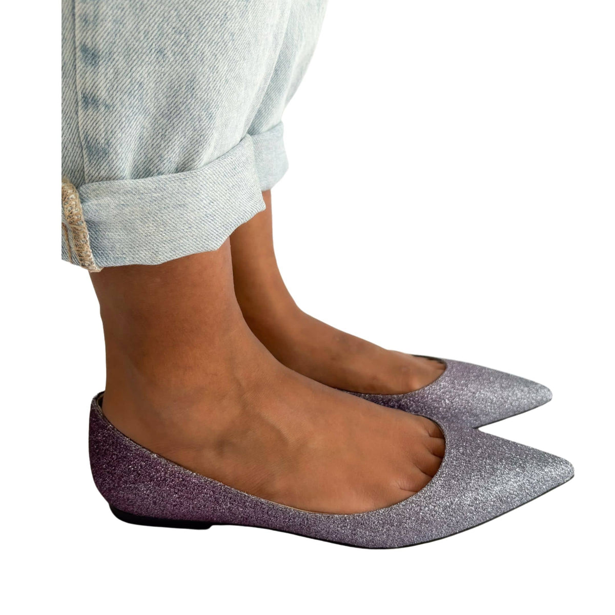 An on-foot perspective of the pointed-toe Jimmy Choo flats, illustrating how the sparkling degradé fabric contours elegantly against the wearer's feet.