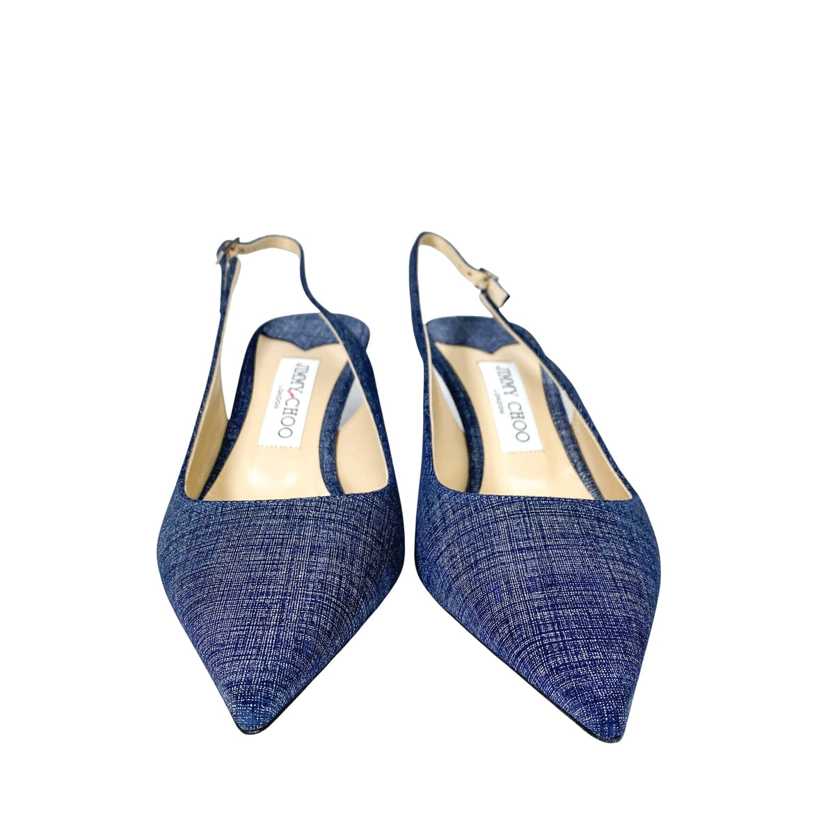 Top-down overhead view of a pair of Jimmy Choo Harper 65 denim luxury heels showing the beige leather footbed and insoles.