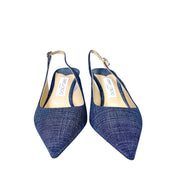 Top-down overhead view of a pair of Jimmy Choo Harper 65 denim luxury heels showing the beige leather footbed and insoles.