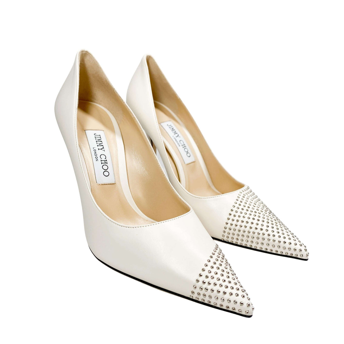 Close-up detail view of Jimmy Choo Love 100 off-white leather pump showcasing the silver mini stud detailing on the pointed toe.