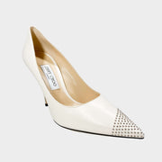 Side profile of Jimmy Choo Love 100 off-white leather pump with asymmetric silver mini studs and 100mm stiletto heel.