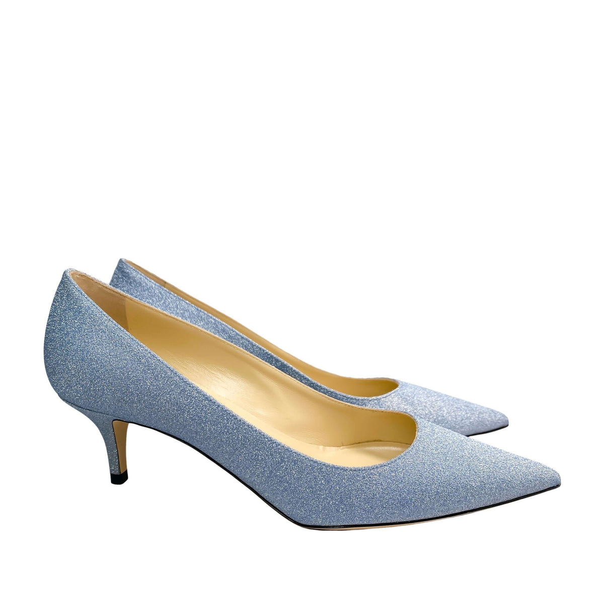 Three-quarter studio view of Jimmy Choo Aza 50 light blue glitter kitten heel pumps highlighting the textured sparkle finish.