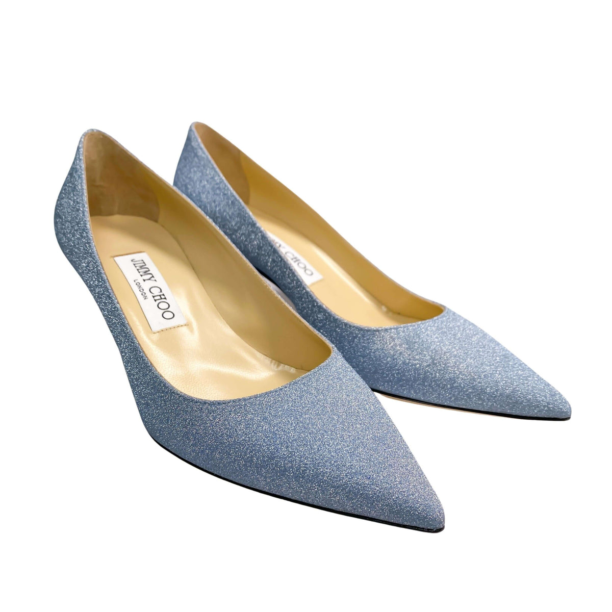 Three-quarter angled pair view of Jimmy Choo Aza 50 light blue glitter pumps showing the inner footbed and profile.